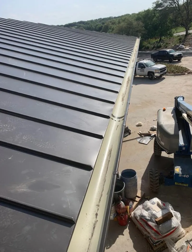 Standing seam panel and gutter detail on a metal roofing jobsite in Waynesboro